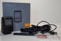 Photo showing Apeman C370 dash camera, box, car charger, USB cable, mount, and adhesive pad on white surface