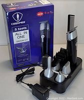 Photo of Ceenwes 5-in-1 cordless groom kit with main grooming device, multiple detachable heads, comb attachments, charging base, power adapter, USB cord, and original box.