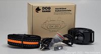 Dog Range smart no shock dog bark control collar in black with orange stripe on nylon strap, USB charging cable, accessories, and original product box.