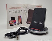 Wireless charging stand with base and USB cable in front of product box showing usage positions.