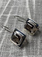 Front view of the pair of sterling silver earrings with faceted smoky quartz stones set in square bezel settings.