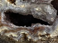 Close-up photo showing sliced geode with crystalline interior and layered outer structure