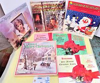 Photo showing seven vintage Christmas LP records with detailed cover art, including Anne Murray, Firestone Your Favorite Christmas Carols volumes, and a boxed set titled 'Have A Merry Christmas'.