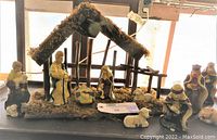 Full view of nativity set with manger and all ceramic figurines displayed together