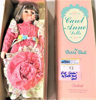 Doll in original Goebel box with the logo Carol Anne Dolls by Bette Ball and auction tag visible. Doll wrapped in plastic inside box.
