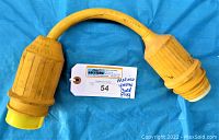 Image showing entire yellow marine electric dock plug cord with molded connectors and auction tag.