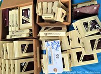 Photo showing multiple cream-colored KEE-PLUS boxes with window displays containing new old stock key cases