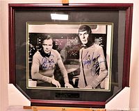 Full frontal view of framed photo with autographs and matting