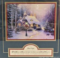 Close-up of the art print showing snowy winter cottage and Christmas scene.