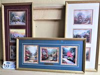 Three framed Thomas Kinkade prints grouped showing variation in mat colors and layout.