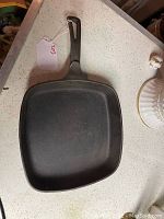Top down view of the square cast iron skillet showing interior cooking surface and handle detail.