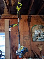 Full view of the Ryobi cordless weed trimmer showing the entire length and trimming head.