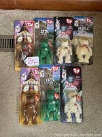 Top view showing all seven Ty Beanie Baby bears in sealed McDonald's packaging with Oak Brook misspelling.