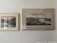 Two framed sketches of Budapest hanging on a wall, different sizes.