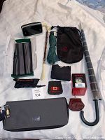 Full view of lot with alarm clock, umbrellas, travel organizer, scarf, watch box, and pouches.