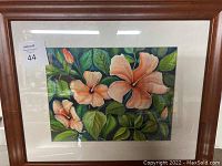 Full view of framed flower painting showing three pink hibiscus flowers and green leaves with wood frame and white matte border.