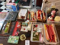 Full overview of the lot showing binders, candles in containers, soaps, and candle holders.