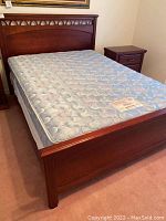 Full view of assembled queen bed frame with mattress placeholder
