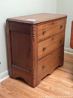 Front angled view showing entire dresser with three drawers and turned corner posts