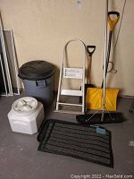 Front view showing all items including two bins, shovels, mats, boot tray, and step stool/handcart