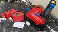 Toro snow thrower with handles, chute, wheels and accessories laid out