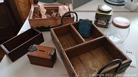 Various vintage wooden boxes, Kraft Cheese wooden box branding, metal tins for Harrods and Edgeworth, York glass jar, and vintage wooden doll bed.