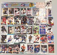 Photo of 28 assorted hockey cards showing players from NHL teams including New York Rangers, Detroit Red Wings, Boston Bruins, and more.