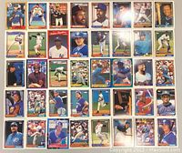 Top view of multiple baseball cards arranged in rows showing player images and card designs.