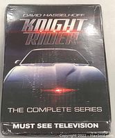 Front cover of Knight Rider Complete Series DVD set with David Hasselhoff and the Knight Rider car on it.