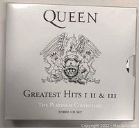 Outer white slipcase with Queen logo and set title in silver foil.