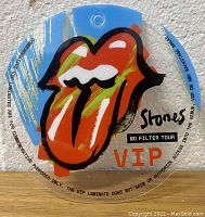 Clear VIP laminate pass with Rolling Stones tongue and lips logo in red, orange, yellow on a blue background with text 'Stones No Filter Tour VIP' and other legal text around edges.