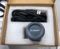 Top view of SVBONY telescope camera eyepiece in the original box showing the USB cable.