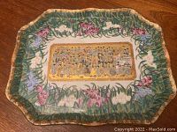 Full view of the scalloped decorative Asian centre plate showing floral border and central painted scene.