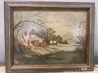 Full view of framed oil on board winter landscape painting showing houses with snow, leafless trees, and winter scene