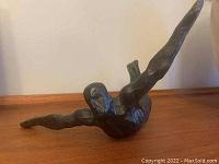 Front angled view of bronze diver coat hook showing sculptural detail and diver pose arms spread wide.