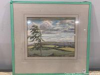 Framed vintage watercolor painting of a tree and landscape showing overall condition and framing