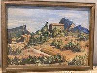 Full view of the framed oil painting showing a landscape with buildings and mountains.