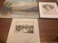 Photo showing all three artworks: the oil painting, the etching, and the portrait print arranged on a table.