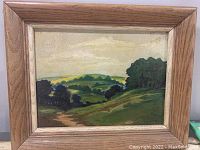 Frontal view of the framed impressionist landscape painting showing the artwork and wooden frame.