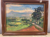 Full view of framed impressionist landscape painting showing countryside scene with green fields, dirt path, trees and blue sky with clouds.