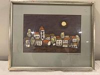 Framed overall view of the batik artwork showing the full village scene and the frame condition.