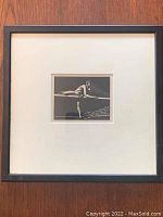 Overall framed engraving against wood backdrop