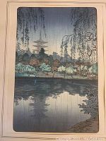 Frontal view of framed woodblock print showing temple scene