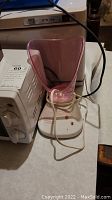 Pink facial steamer on white tabletop next to RTD 16A controller