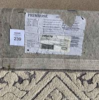 Back of rolled rug showing Primrose label with design number, color and size