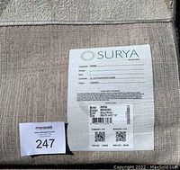 Label on the back of the rug showing brand Surya, model Roma, 100% polypropylene, made in Turkey with care instructions and size info 200x75 cm.