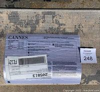 Photo of the rug label showing brand name Cannes and care instructions on the back side of rug