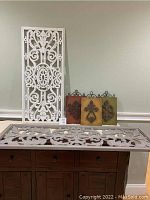 Full group image showing large white wood panel, three smaller metal panels in different colors, and a white carved panel laying flat