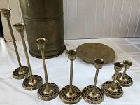 Close-up of brass candle sticks with patterned cut-out bases