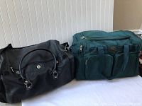 Black and green duffel bags side by side showing overall appearance and size